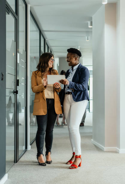istock Two Happy Female Colleagues Using Digital Tablet Together at Work 1372381199
