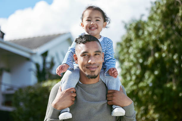 Shot of a young man carrying his daughter on his shoulders Spending quality time with my daughter single father stock pictures, royalty-free photos & images
