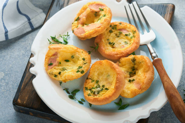 istock Egg muffins with green onions, bacon, cheese and tomatoes on white plate on light background. Healthy high protein and low carb breakfast, ready to eat. 1372386038