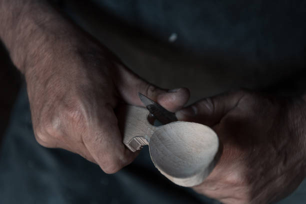 istock Spoon craft master in his workshop with handmade wooden products and tools working 1372386611
