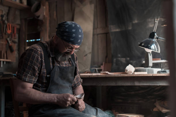 istock Spoon master in his workshop with wooden products and tools 1372388124