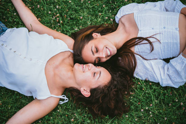 istock Two laughing girls looking at each other 1372389303