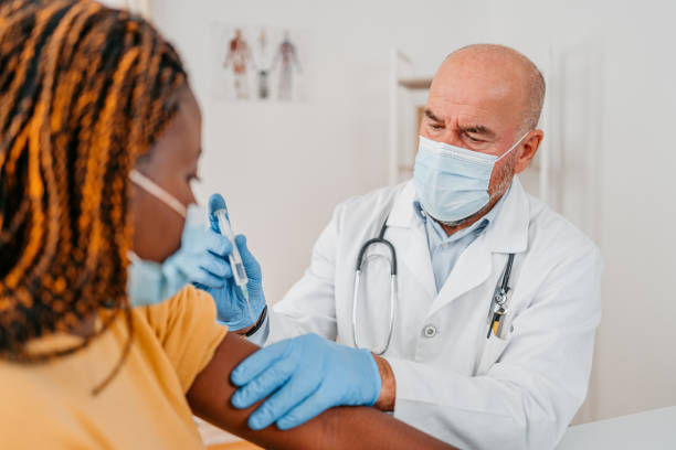 istock Young Woman Getting Vaccinated By The Doctor 1372389390