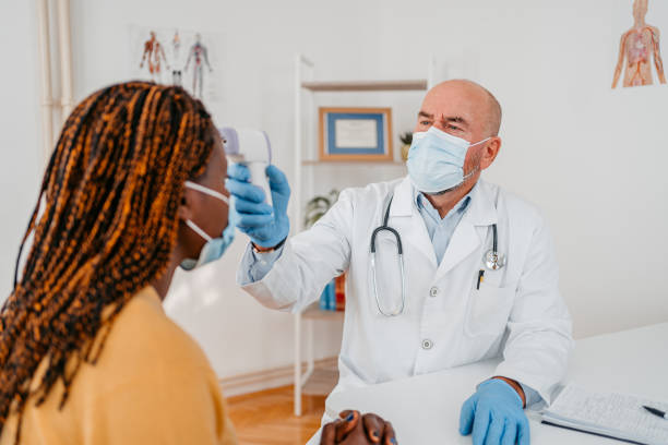 istock Doctor Checking The Temperature Of A Patient 1372389592