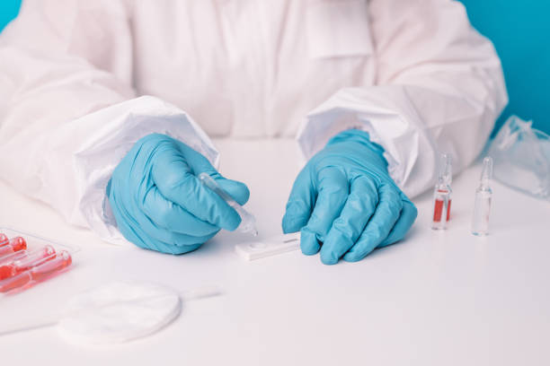 istock Doctor in blue gloves using COVID-19 coronavirus Covid-19 rapid antigen test over blue background 1372390796