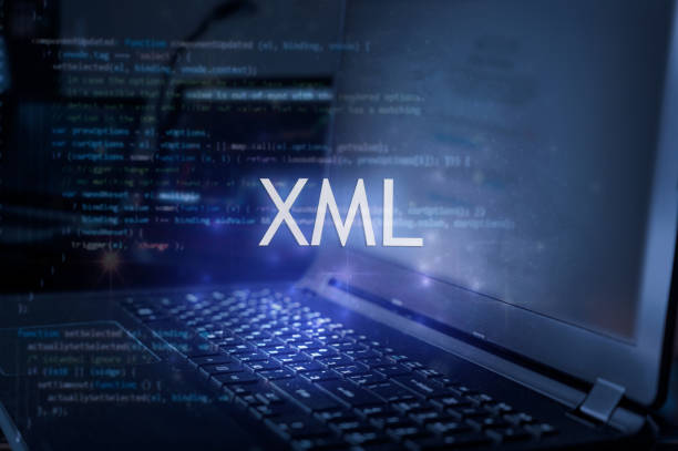 XML inscription against laptop and code background. stock photo