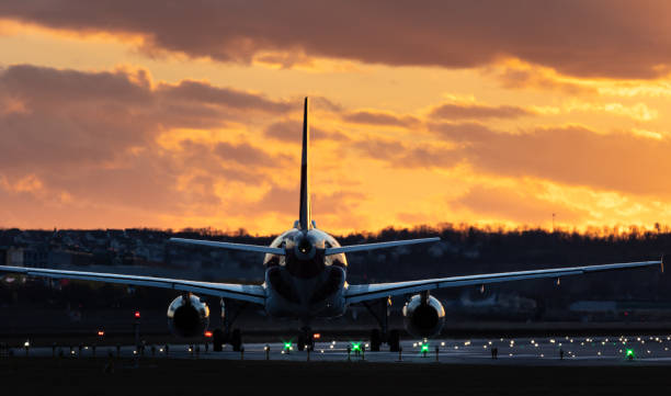 istock Airplane ready for take off againts sunset sky. 1372395075