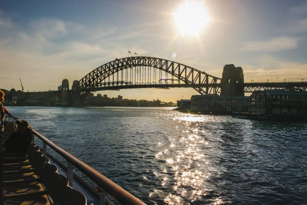 istock View of Sydney Harbor Bridge with sun setting behind it; view from a ship 1372396828