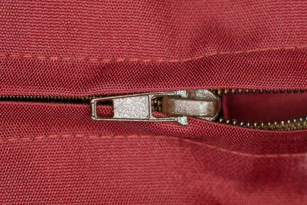istock one brown metal open zip on a red fabric 1372396969