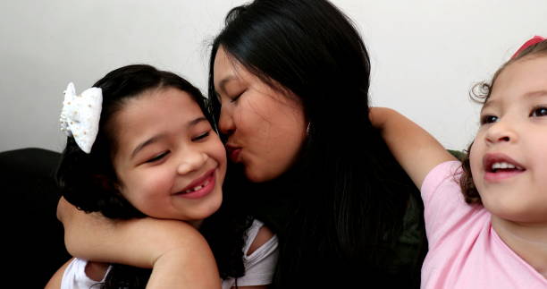 istock Asian mother holding and embracing daughters 1372397743