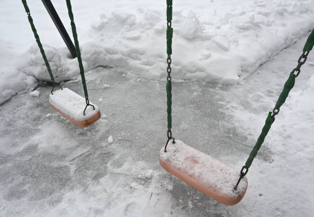 swing on the playground in the yard in winter in Finland