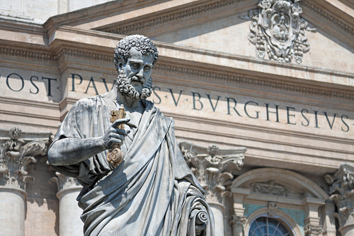 Vatican (Holy See) - Rome - Italy - The statue of saint peter with key in hand and st Peter's basilica at blurred background on st peter's square