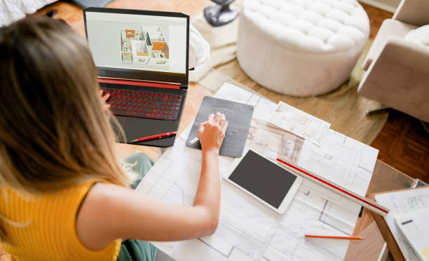 istock Female designer working on new interior designs on her laptop 1372400808