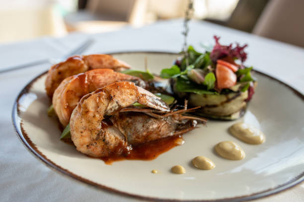 istock Grilled scampi(large prawn) served with greenery on white plate 1372401533