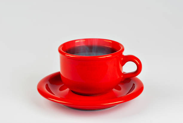 istock Ceramic red coffee mug close up. Coffee isolated on a white background. Copy space and free space for text near the drink. 1372404875