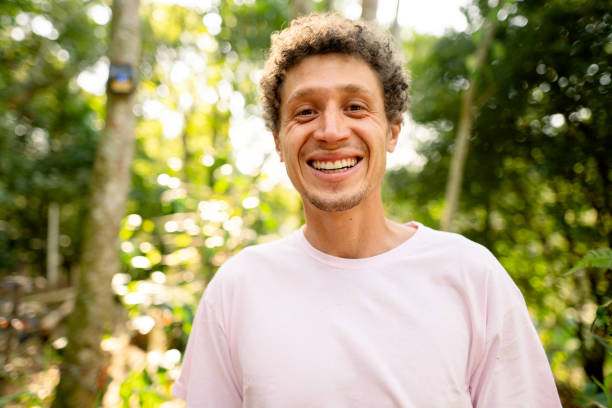 istock Laughing young man standing outside on a sunny summer day 1372407244