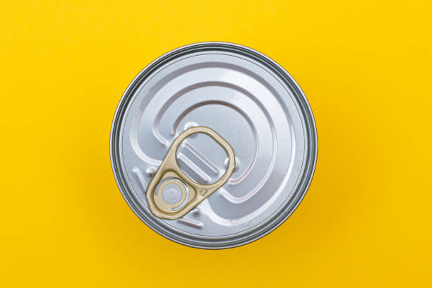 istock Unopened Tin Can with Blank Edge on Yellow Background 1372407965