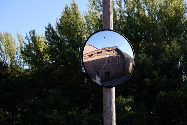 Broken mirror traffic sign Broken mirror traffic sign with tree and a house convex stock pictures, royalty-free photos & images