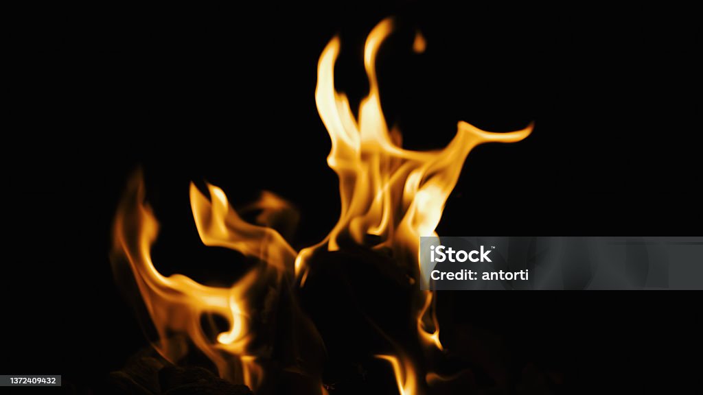 Fire burning Fire burning on a black background. Ideal for compositing with another image. The background can be removed with a blending mode like screen. Backgrounds Stock Photo