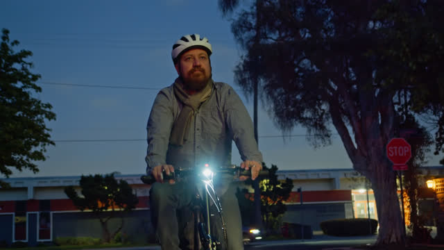Man Riding Bicycle Home at Night