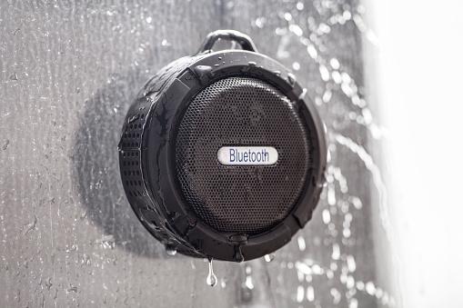 Wireless black bluetooth speaker shower radio in wet shower
