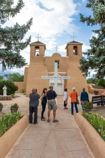 Ranchos de Taos, NM, USA-12 July 18: The San Francisco de Asis Mission Church was finished in ~1815. Image includes tourists at front of church.