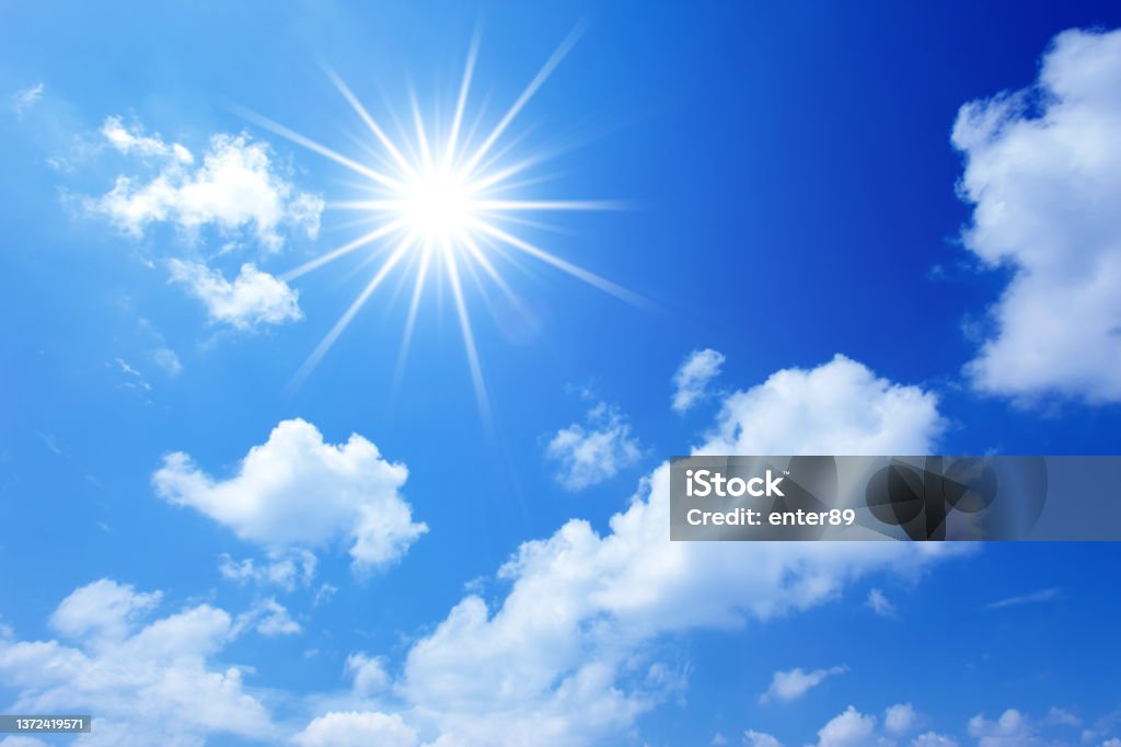 Sun on blue sky Sun on blue sky with clouds Sunlight Stock Photo