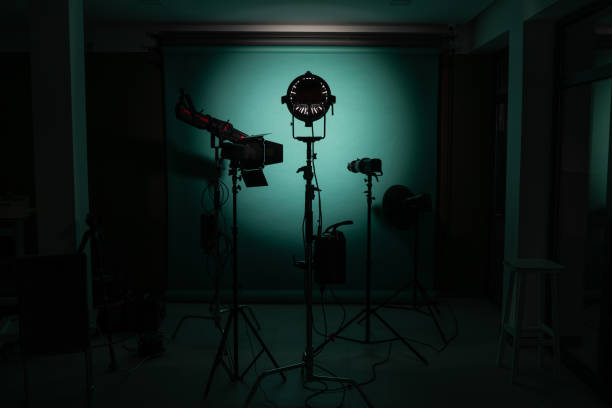 Empty dark studio with photography lighting.