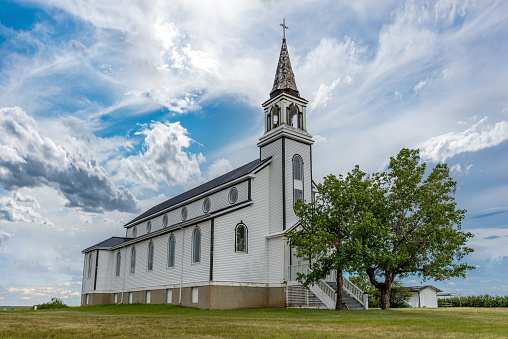 A dramatic sky over the Blumenfeld Roman Catholic Church near Leader, SK, Canada