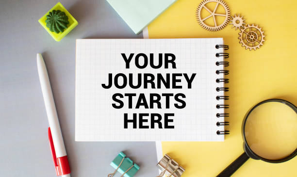 istock text Your Journey Starts Here on white paper 1372422433
