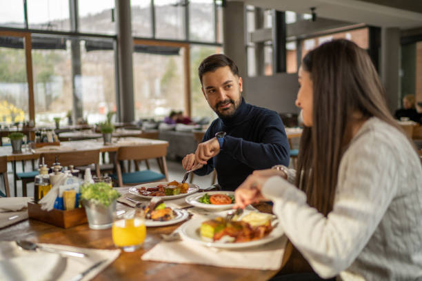 Man and woman eating in restaurant