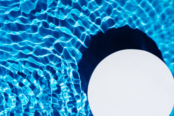 istock White circle copy space in transparent fresh blue water surface with flecks, waves, shade. Health care spa in summer 1372426301