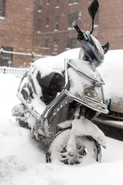 motorrad unter schnee auf der straße - motorcycle snow winter new york city stock-fotos und bilder