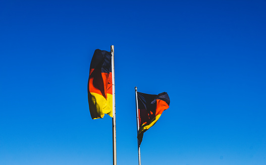 Two German flags in the blue sky