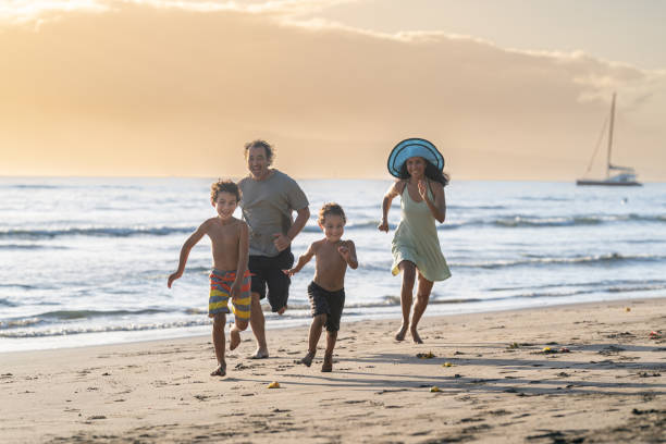 istock Happy family playing at the beach 1372429449