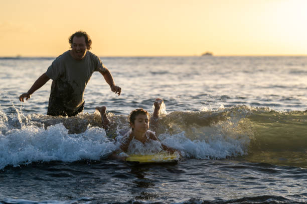 istock Little boy learning to body board 1372429453