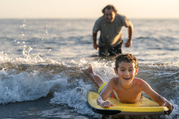 istock Excited boy learning to body board 1372429460
