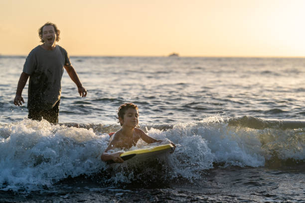 istock Little boy learning to body board 1372429465