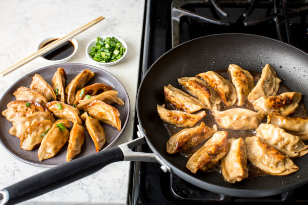 istock Cooking seafood and pork dumplings in the kitchen 1372430716