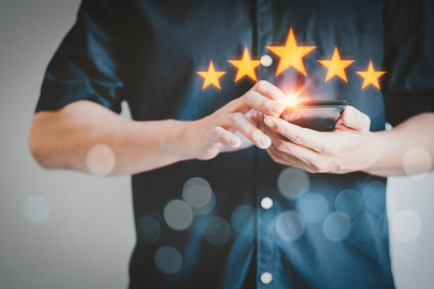 istock Man using a smartphone in give rating to service experience on application. Online customer review satisfaction feedback survey. 1372433435