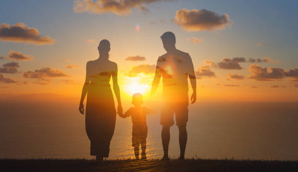 istock Happy family walking at sunset. 1372439027