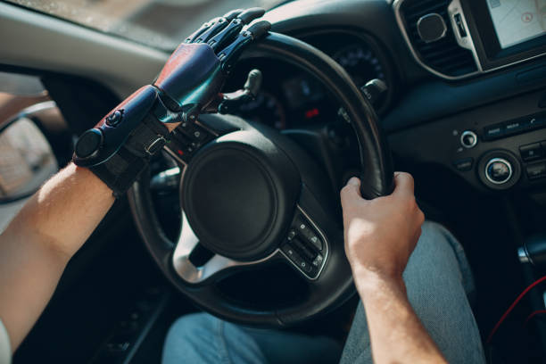 istock Young disabled man driver with artificial prosthetic hand driving vehicle car. 1372441209