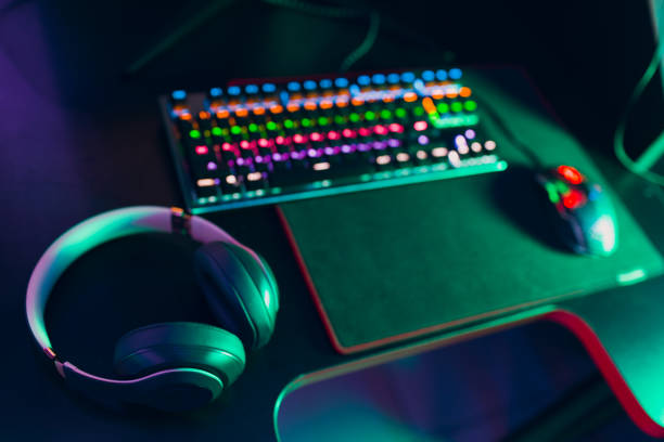 istock Computer keyboard monitor mouse headset speakers on table 1372441774