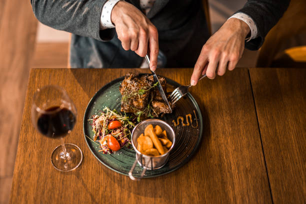 istock Unrecognizable young man eating lunch at a restaurant. 1372442953