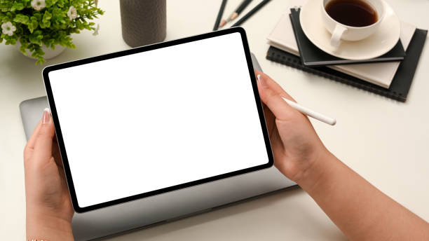 istock Female hand holding a digital portable tablet touchpad 1372450081