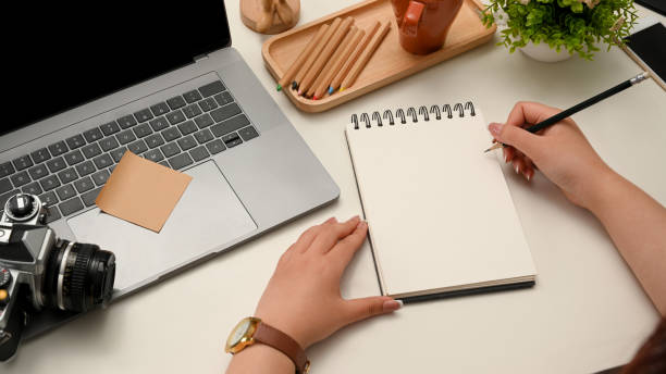 istock Female writing her travel reviews on spiral notepad 1372450086