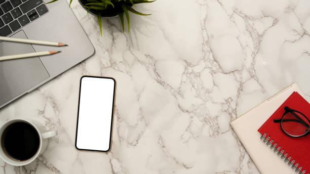istock Minimal office worktable with smartphone mockup on marble background. 1372450201