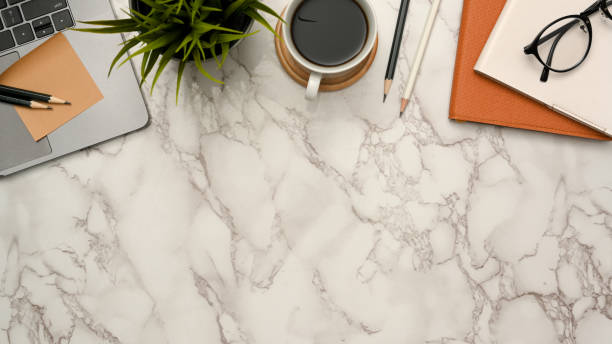 istock Office desk with office supplies and copy space on marble background. 1372450205