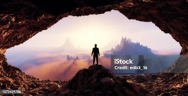 Dramatic View Of Adventurous Man Standing Inrocky Cave Mountain Landscape Stock Photo - Download Image Now