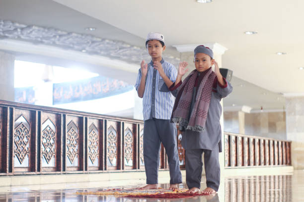 istock Muslim boys salat in the mosque 1372461427